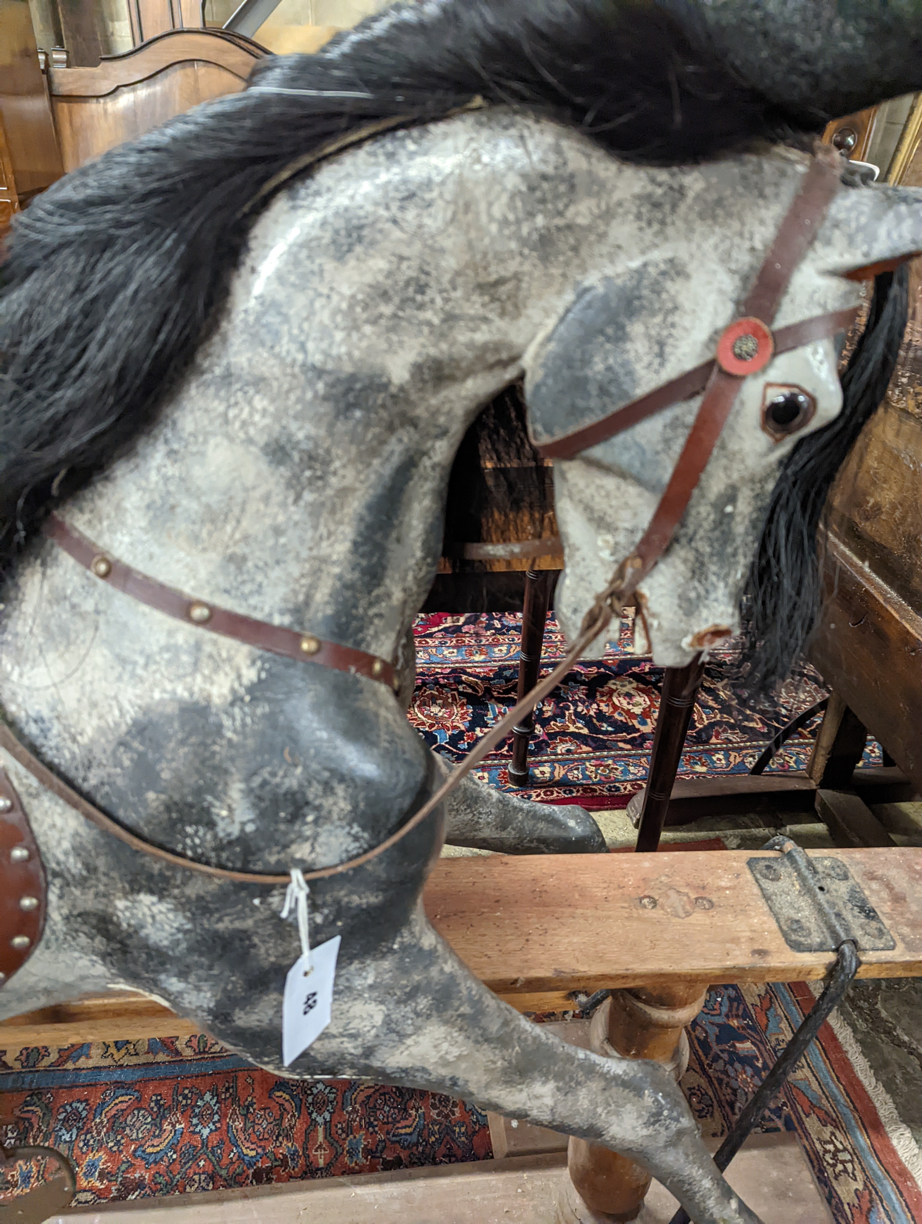 A large Edwardian Ayres type rocking horse on a turned safety frame, length 160cm, height 110cm